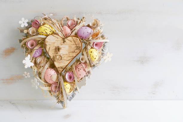 istock Valentine easter wreath with eggs and flowers, heart shape on white 913378094