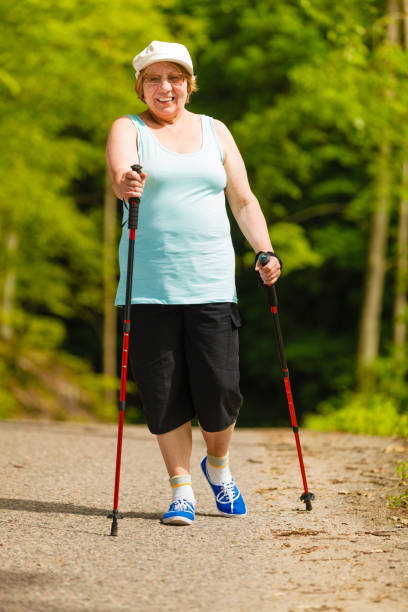 istock Senior woman practicing nordic walking in park 913378292