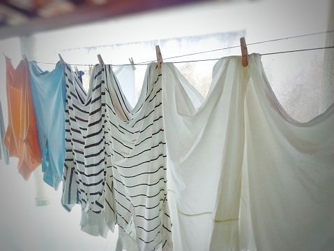 Wet clothes drying in the sun. Laundry  hanging in back yard. Galicia, Spain.