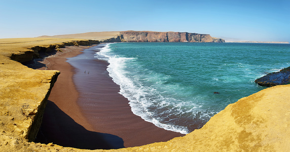 The coast and red sand beach of Paracas National Reserve in Peru