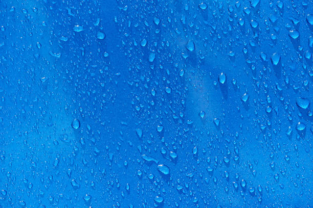 istock Rain drops on blue metal background 913387494