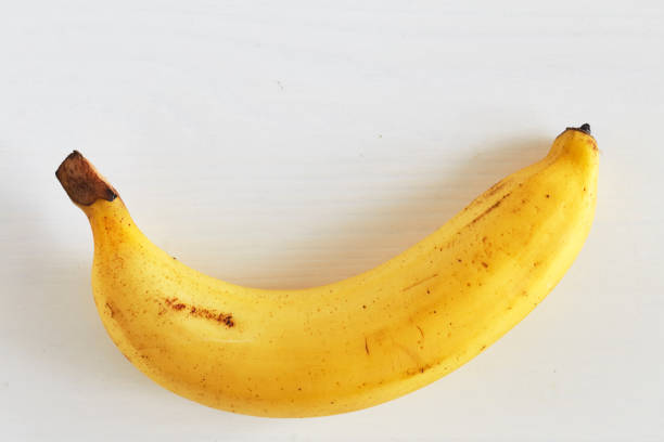 istock banana on rustic white wooden table background 913394370