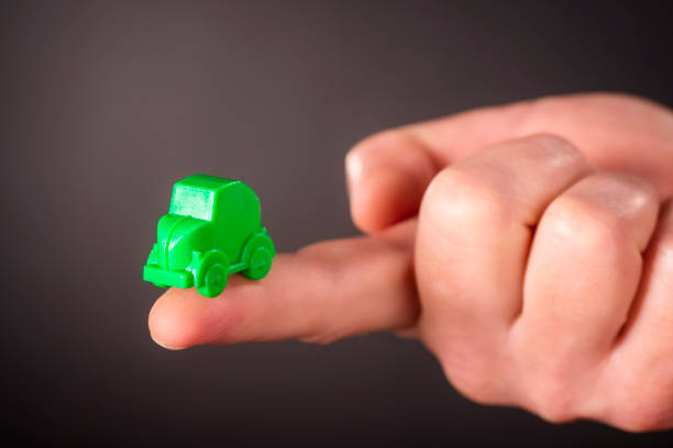 istock Finger with little green car 913403114