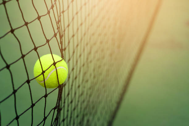 istock Close up Tennis ball hitting to net 913405764