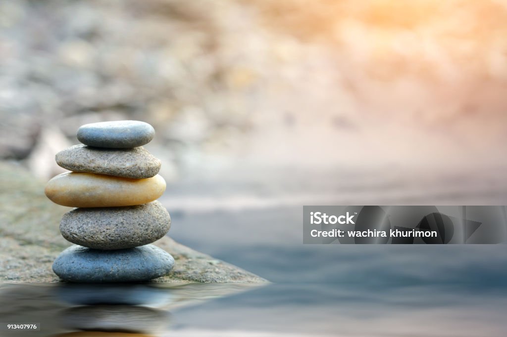 Balance stone with spa on river coast Wellbeing Stock Photo