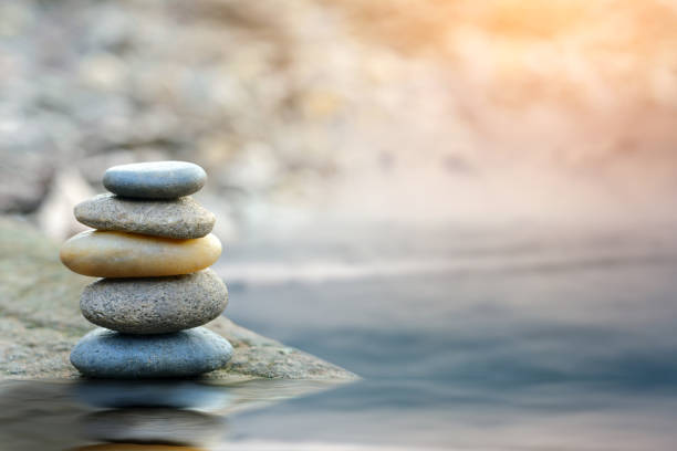 Balance stone with spa on river coast Balance stone with spa on river coast wellbeing photos stock pictures, royalty-free photos & images