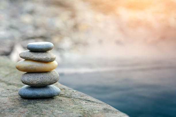 istock Balance stone with spa on river coast 913407984