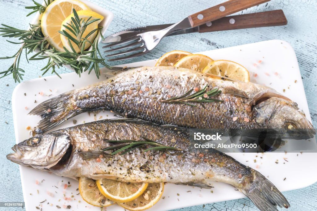 Baked sea bass with lemon and rosemary Fish Stock Photo