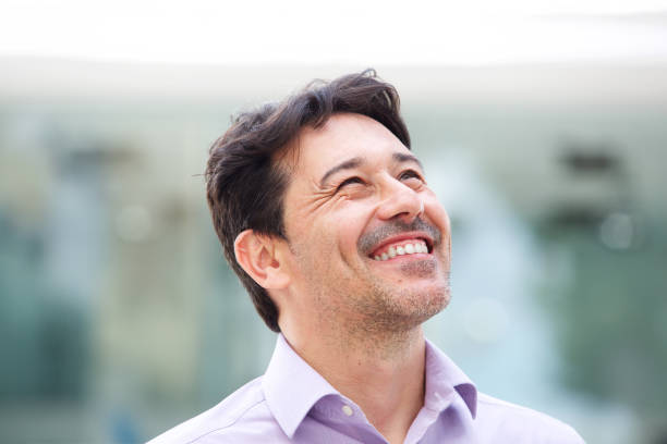 istock Close up happy older man looking away and smiling outside 913415338