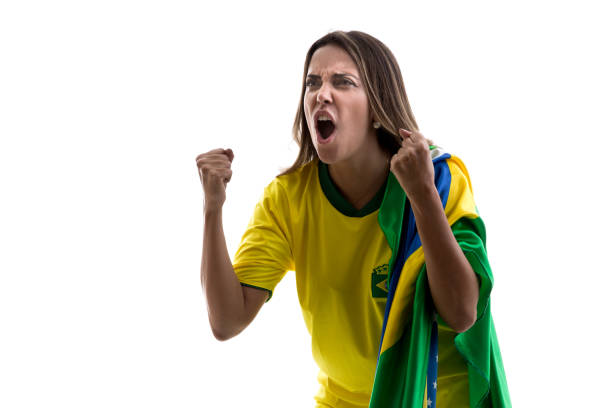 istock Brazilian female fan celebrating on white background 913422932