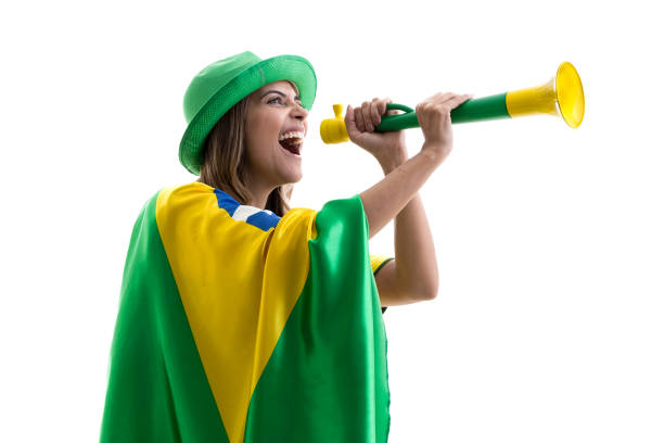 istock Brazilian female fan celebrating on white background 913423040