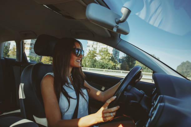 istock Attractive brunette drives a car 913423690