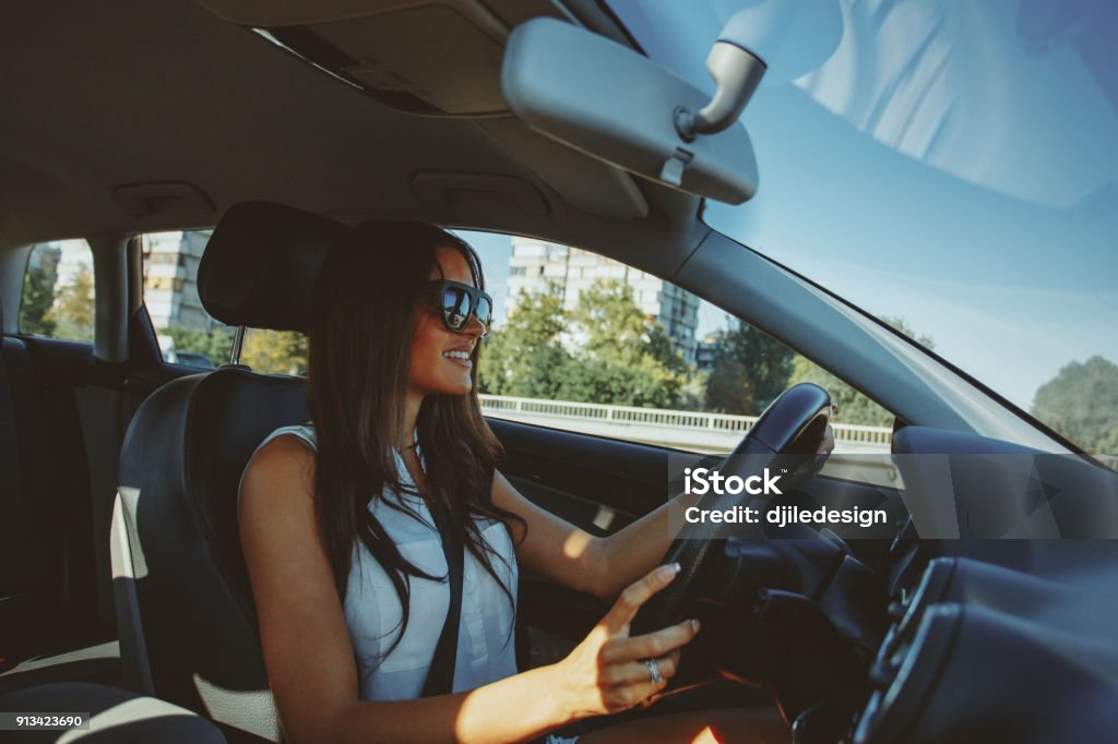 Attractive brunette drives a car Driving Stock Photo