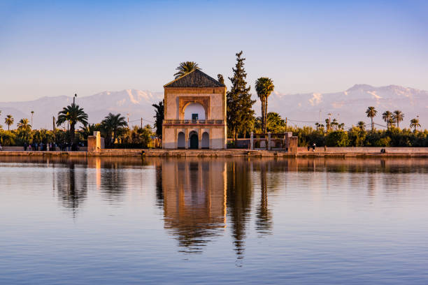 Saadian pavilion,Menara gardens and Atlas in Marrakech, Morocco, Africa Saadian pavilion,Menara gardens and Atlas in Marrakech, Morocco, Africa at sunset. Water reflection. desert oasis photos stock pictures, royalty-free photos & images