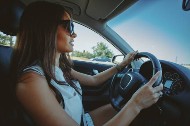 istock Attractive brunette drives a car 913427448