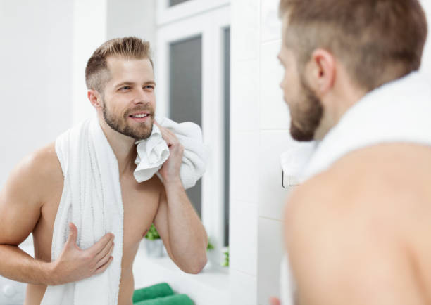 istock Morning hygiene, Man in the bathroom looking in mirror 913432196