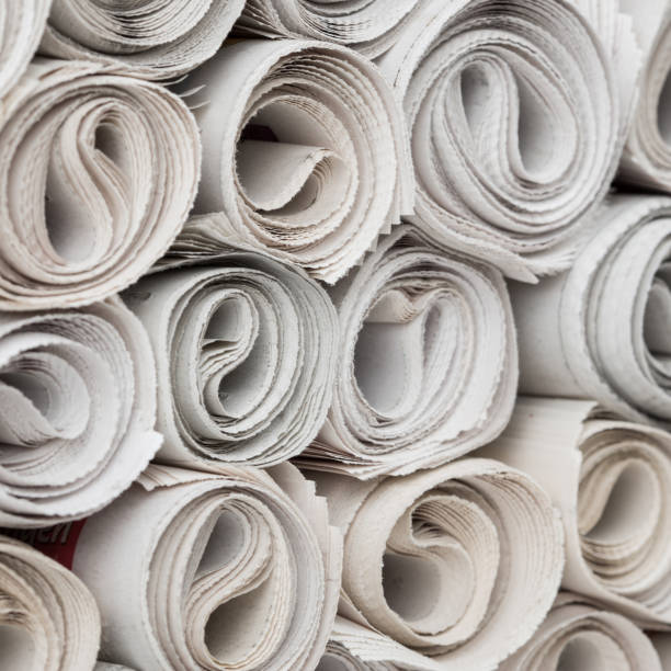 rolls of newspapers - tabloid newspaper rolled up journalist imagens e fotografias de stock