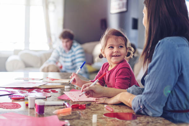 istock Valentine's Day, mother making valentine cards 913438516