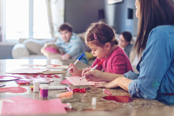 istock Valentine's Day, mother making valentine cards 913438550