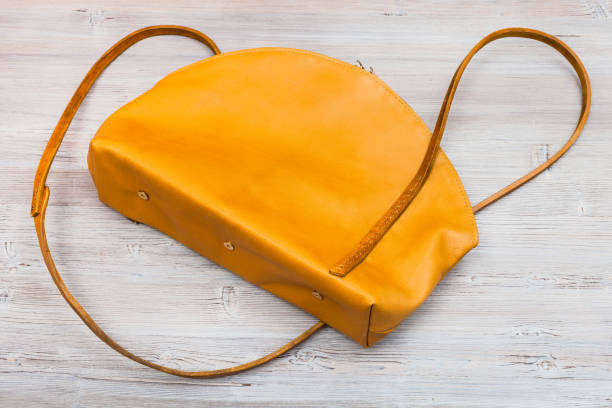 istock back side of yellow leather bag on wooden table 913438566
