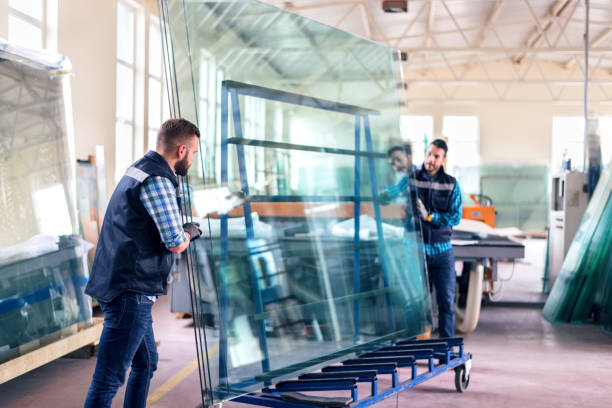 workers packaging glass sheets in warehouse - glass factory imagens e fotografias de stock