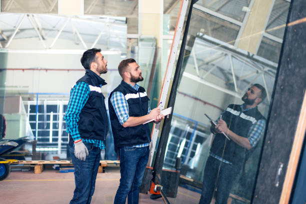 istock Workers handling glass sheet in warehouse 913442400