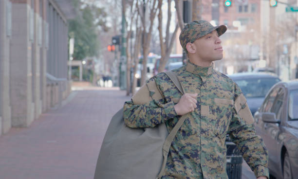 istock Military Man Walks on Urban Street Setting 913445592