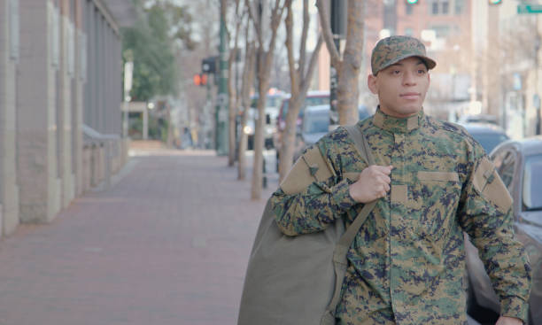 istock Military Man Walks on Urban Street Setting 913445600