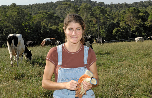 portrait of a woman farmer with some cows