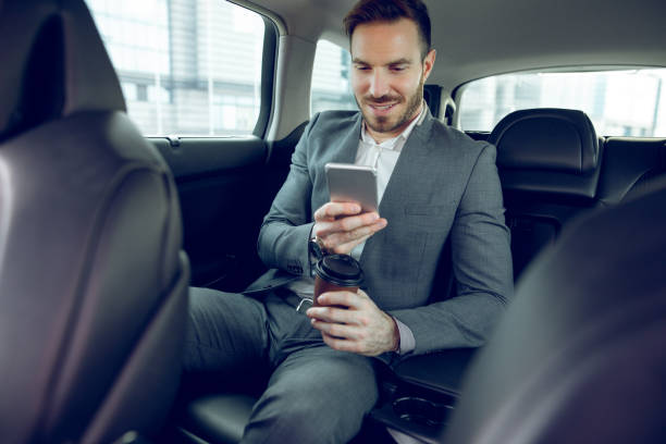 istock Successful businessman in a car and text messaging 913454068