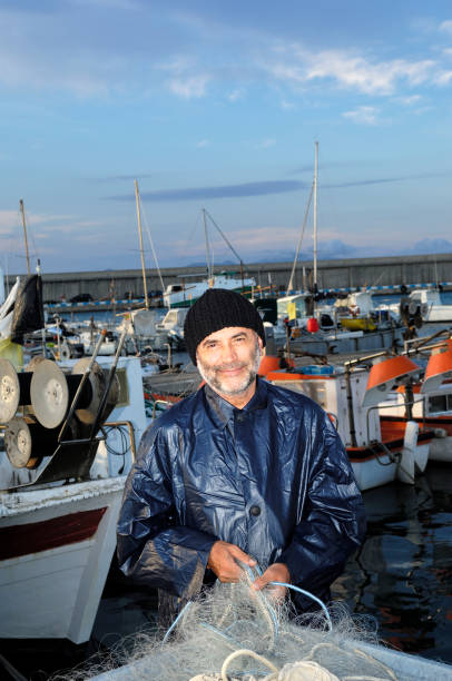 istock fisherman working in the fishing port 913456832