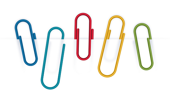 Colorful metal paperclips isolated on white.