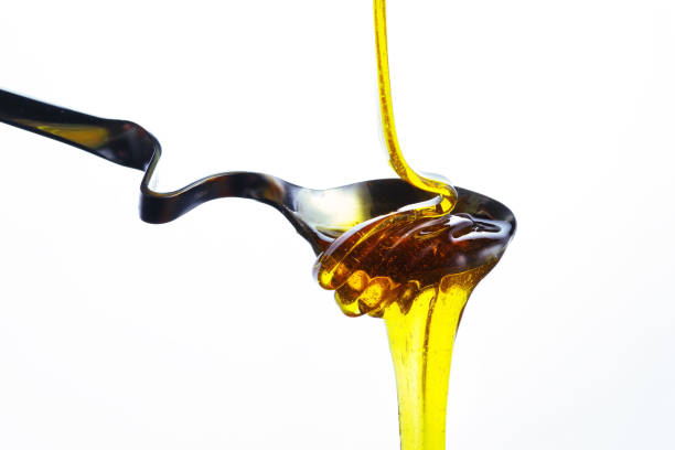 istock Spoon with honey on a white background. Isolated. 913476476