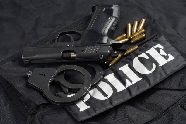 istock Police uniform with handgun and ammunition 913482946