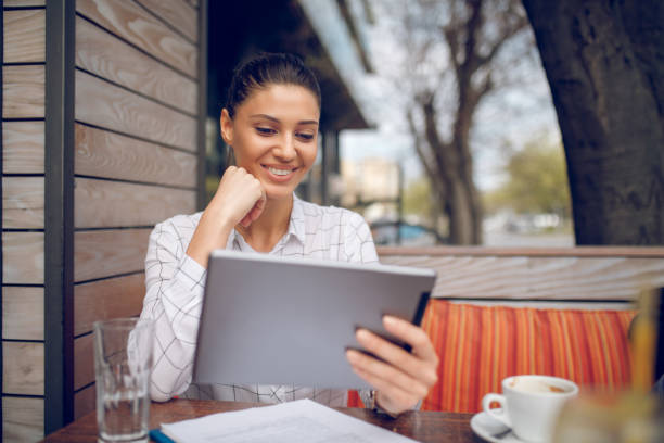 istock Cheerful businesswoman using tablet computer outdoors 913488422