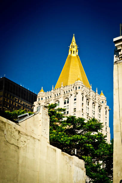 New York Life Building New York Life Building viewed through high rise buildings and a construction lift for a new skyscraper on the right. new york life building stock pictures, royalty-free photos & images