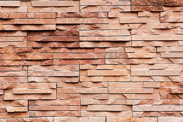 brick wall with uneven stones stock photo