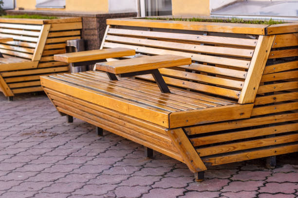 istock A wooden bench with tables on a stone pavement. 913491964