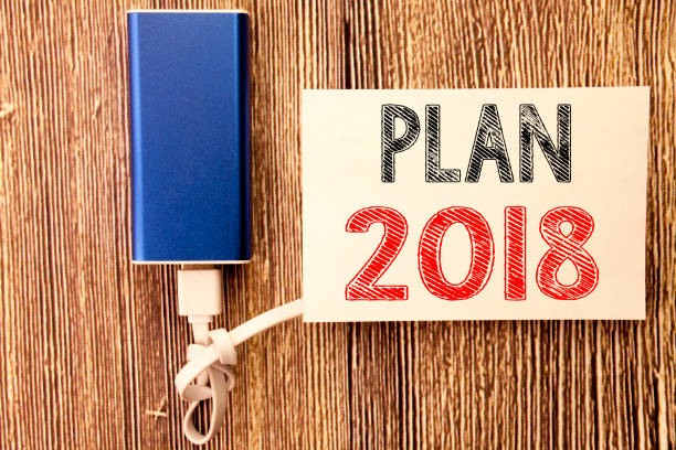 istock Conceptual hand writing text caption inspiration showing Plan 2018. Business concept for Planning Strategy Action Plan written on sticky note old wood wooden background with power bank 913491994