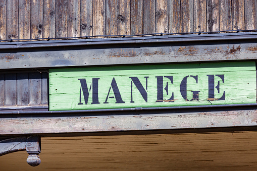 vintage sign at the entrance of an equestrian carousel on which is inscribed the word carousel (