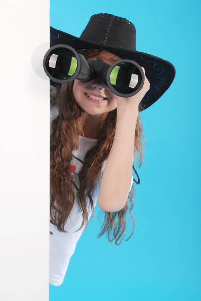若い女の子、双眼鏡 - corner child hiding looking ストックフォトと画像