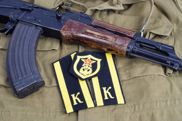 istock AK47 with Soviet Army Cadet shoulder mark and Soviet Army Combat engineer shoulder patch on khaki uniform background 913499858