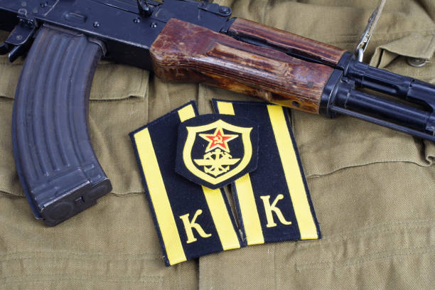 istock AK47 with Soviet Army Cadet shoulder mark and Soviet Army Military engineer shoulder patch on khaki uniform background 913499918