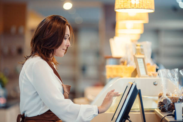 istock Middle age barista typing on cash register 913500234