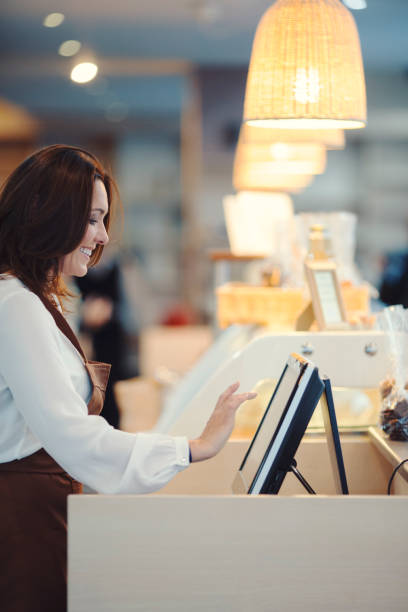 istock Middle age barista typing on cash register 913500310
