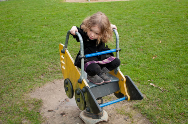 istock Little Girl Playing on Toy Backhoe 913500494