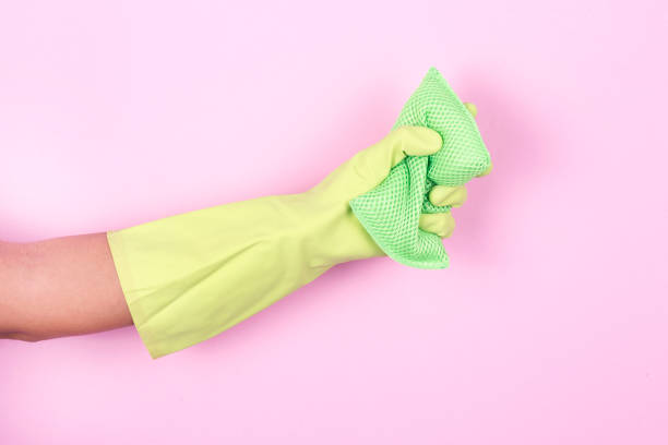 istock Hand in yellow protective glove cleaning with rag 913500992