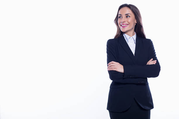 Young smiling confident business woman looking directly into the camera with arms crossed isolated on white background. Concept of office work. stock photo