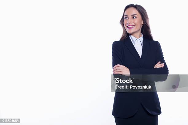 Young Smiling Confident Business Woman Looking Directly Into The Camera With Arms Crossed Isolated On White Background Concept Of Office Work Stock Photo - Download Image Now