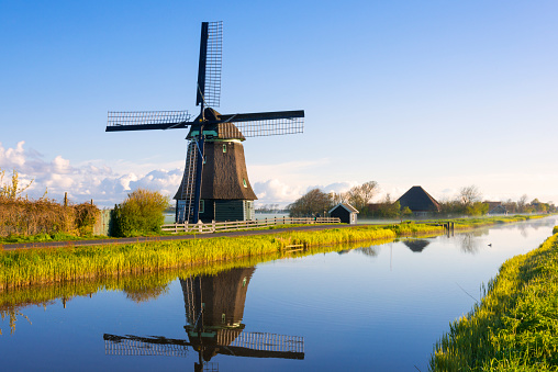 Dutch windmill along a canal